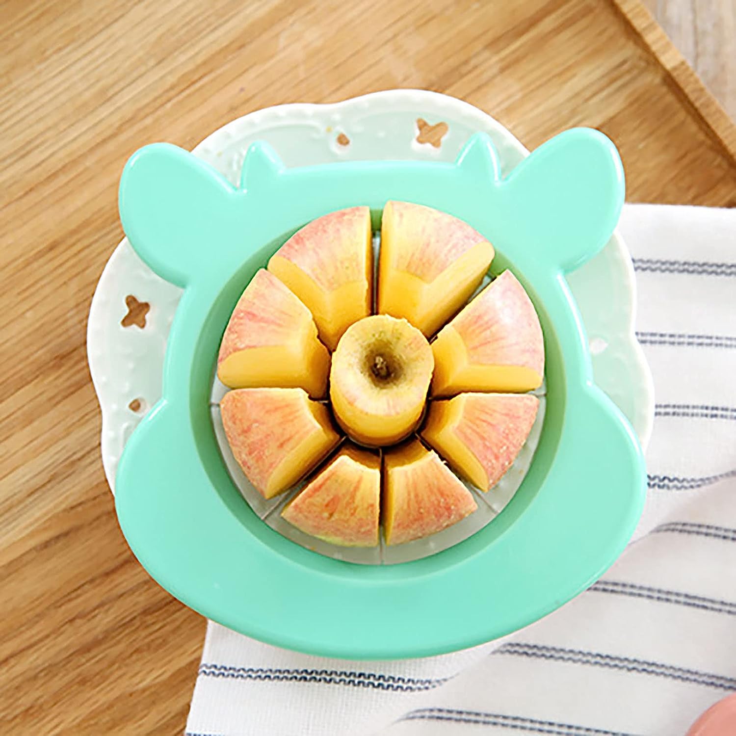 Apple cutter and corer tool, made of stainless steel, designed for slicing and peeling. Apple cutter and corer tool, made of stainless steel, designed for slicing and peeling.